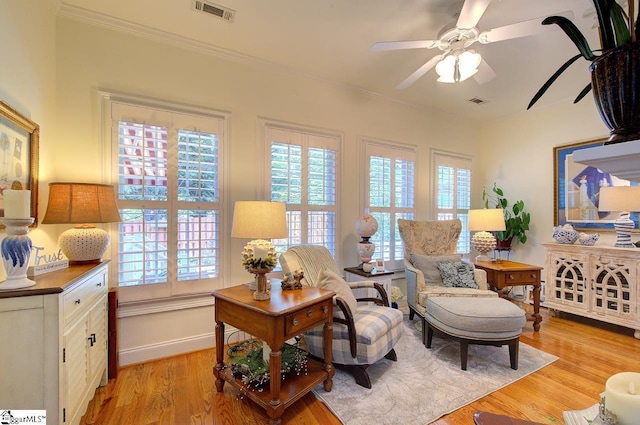 132 Hartsfield Dr, Easley, SC 29642 - living room with a ceiling fan, visible vents, crown molding, light wood-type flooring, and baseboards