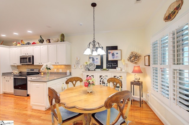 132 Hartsfield Dr, Easley, SC 29642 - dining area with crown molding, baseboards, a notable chandelier, recessed lighting, and light wood-style flooring