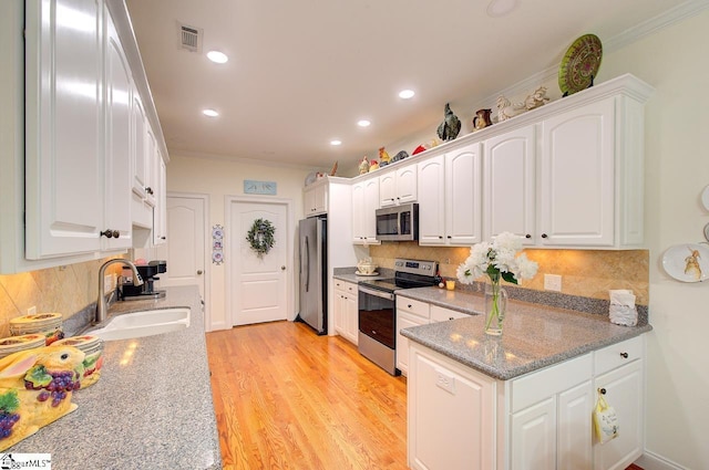 132 Hartsfield Dr, Easley, SC 29642 - kitchen featuring stainless steel appliances, ornamental molding, a sink, and white cabinetry