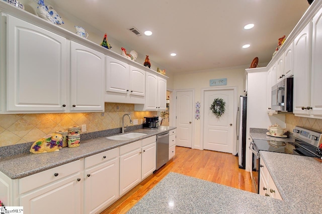 132 Hartsfield Dr, Easley, SC 29642 - kitchen with a sink, stainless steel appliances, white cabinetry, light wood-type flooring, and visible vents