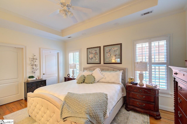 132 Hartsfield Dr, Easley, SC 29642 - bedroom featuring crown molding, a raised ceiling, and light wood-style flooring