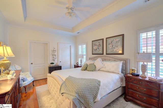 132 Hartsfield Dr, Easley, SC 29642 - bedroom with crown molding, a raised ceiling, a ceiling fan, and light wood finished floors