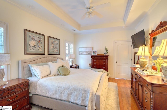 132 Hartsfield Dr, Easley, SC 29642 - bedroom with ceiling fan, a raised ceiling, light wood-style floors, visible vents, and ornamental molding