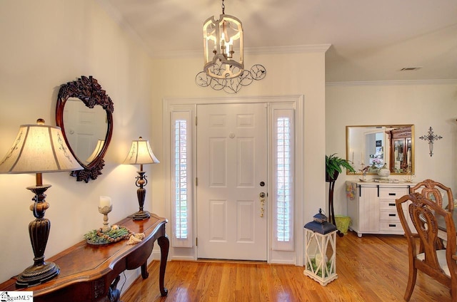 132 Hartsfield Dr, Easley, SC 29642 - foyer with visible vents, ornamental molding, wood finished floors, and a notable chandelier