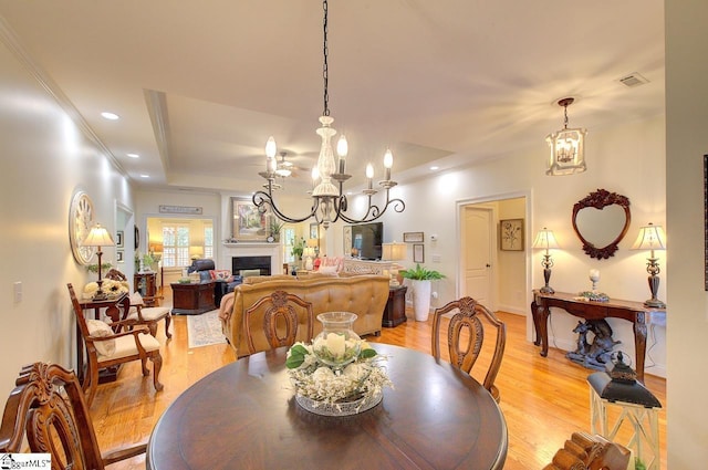132 Hartsfield Dr, Easley, SC 29642 - dining room with visible vents, a fireplace, a notable chandelier, recessed lighting, and light wood-style flooring