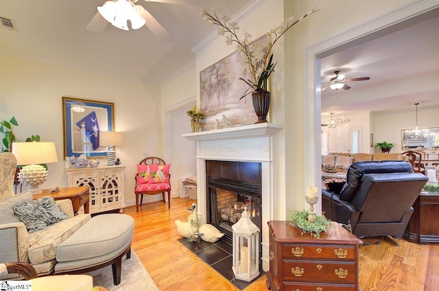 132 Hartsfield Dr, Easley, SC 29642 - living room with crown molding, wood finished floors, ceiling fan with notable chandelier, and a fireplace