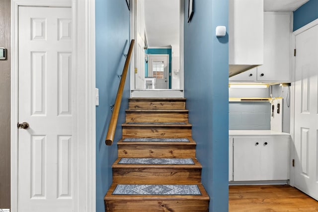 stairway with wood finished floors