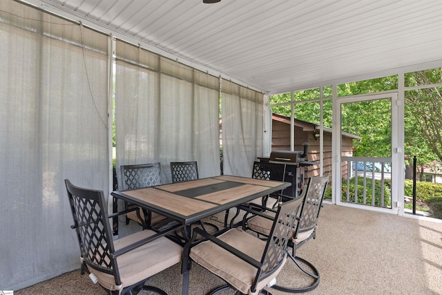 sunroom featuring outdoor dining space