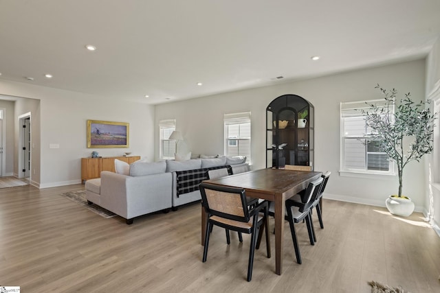 dining room with light wood-style floors, baseboards, and recessed lighting