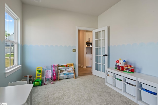 recreation room featuring carpet and a healthy amount of sunlight