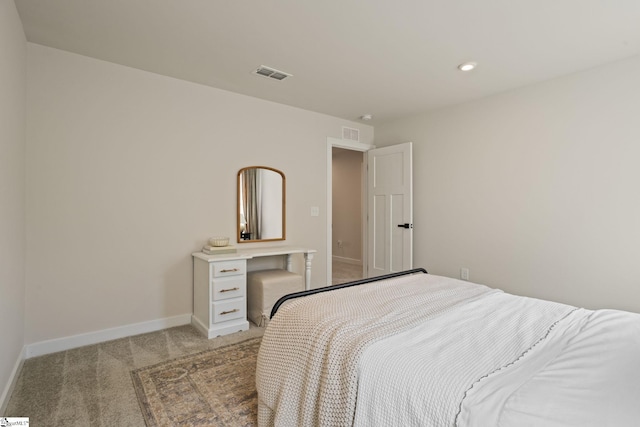 bedroom with baseboards, visible vents, and light carpet
