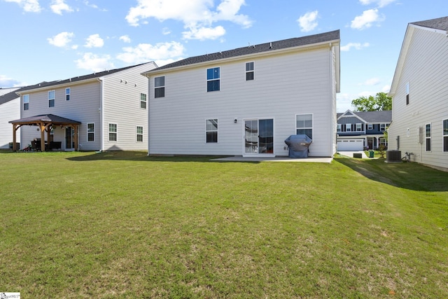 rear view of house featuring a gazebo, central AC unit, a lawn, and a patio