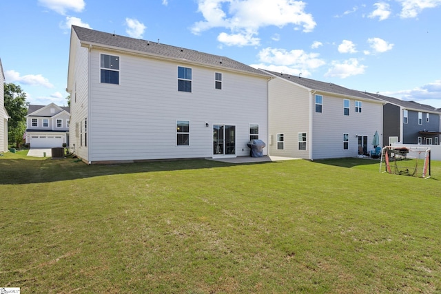 rear view of property featuring a yard, central AC, and a patio area