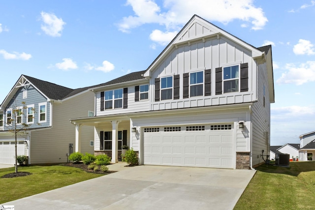 craftsman inspired home with a front lawn, stone siding, board and batten siding, concrete driveway, and an attached garage