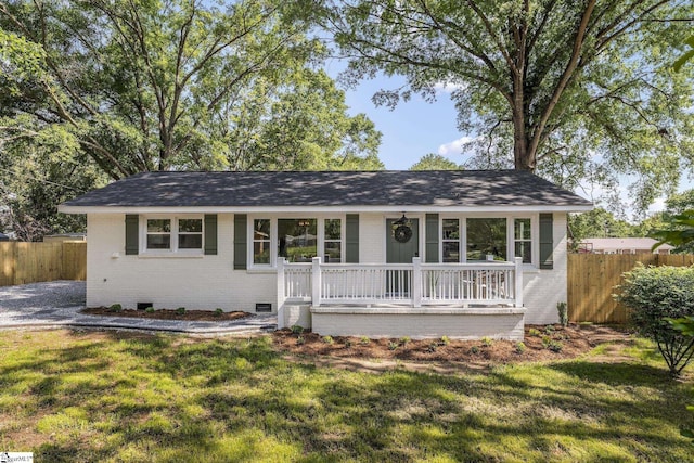 ranch-style house with brick siding, crawl space, fence, and a front lawn