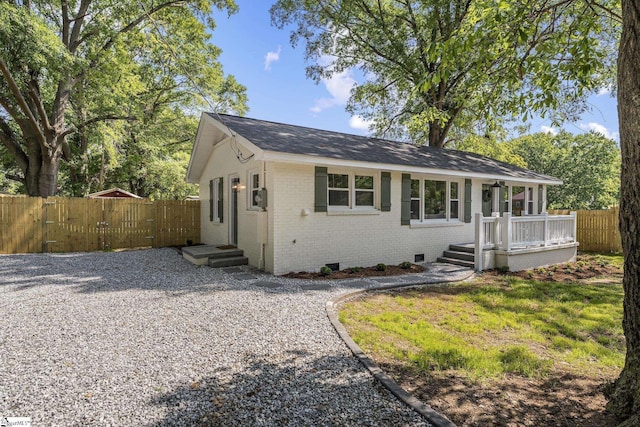 ranch-style home with brick siding, a shingled roof, fence, and crawl space