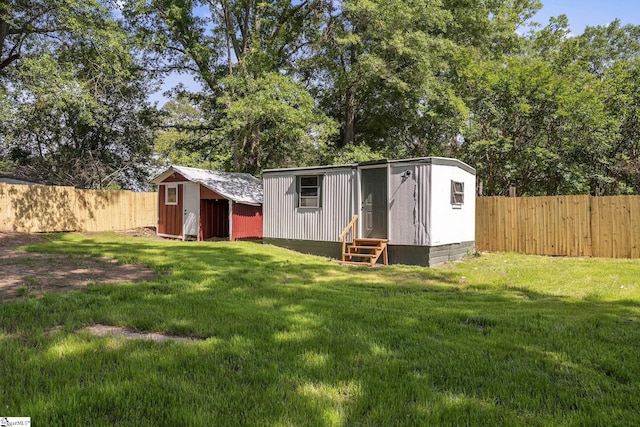 view of shed with entry steps and a fenced backyard
