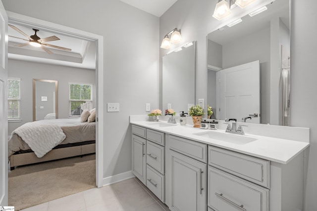 ensuite bathroom with double vanity, tile patterned floors, a sink, and ensuite bath