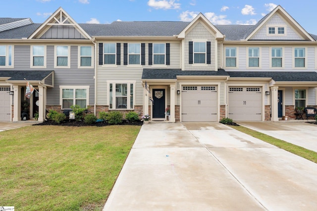 view of property featuring concrete driveway, an attached garage, roof with shingles, and a front lawn