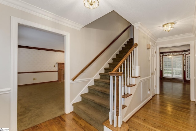 5 Bellfort Ct, Taylors, SC 29687 - stairs featuring crown molding, baseboards, wood finished floors, and a chandelier