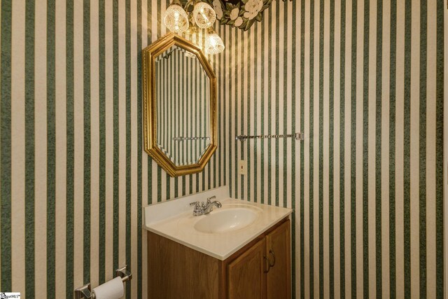 5 Bellfort Ct, Taylors, SC 29687 - bathroom with vanity, wallpapered walls, and a notable chandelier