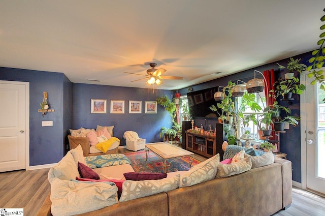 living room featuring plenty of natural light, a ceiling fan, and wood finished floors