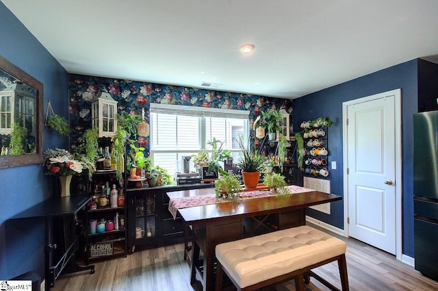 dining area with visible vents and wood finished floors