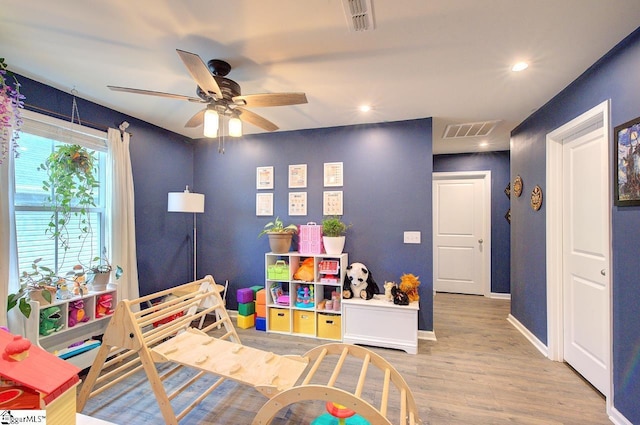 bedroom with recessed lighting, wood finished floors, and visible vents