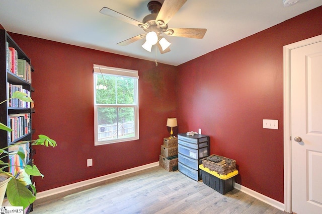 miscellaneous room with a ceiling fan, baseboards, and wood finished floors