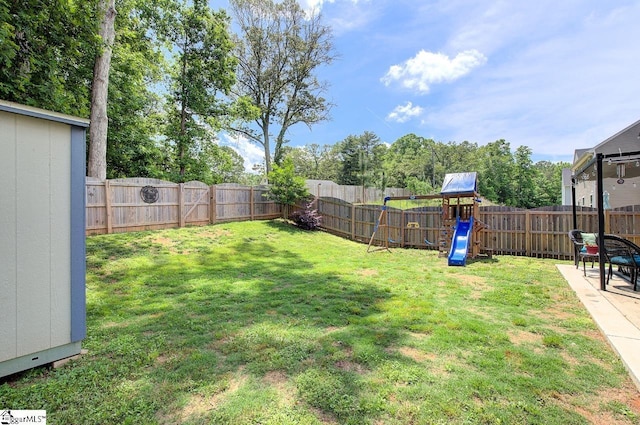 view of yard featuring a playground and a fenced backyard