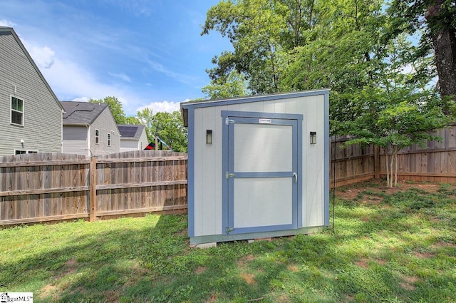 view of shed with a fenced backyard