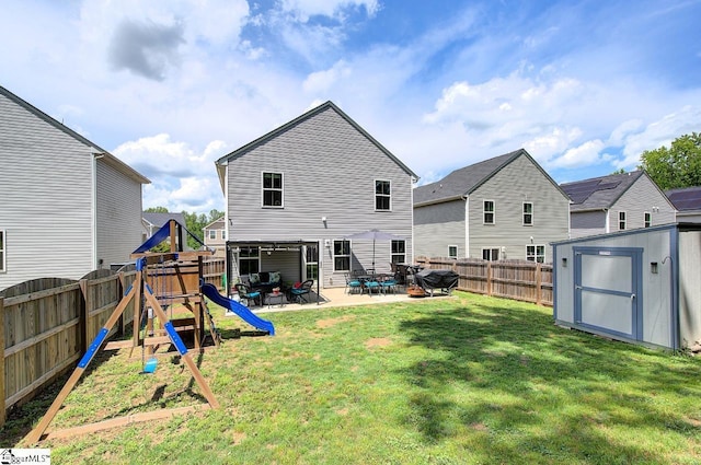 back of house with a yard, a fenced backyard, a shed, and a patio area