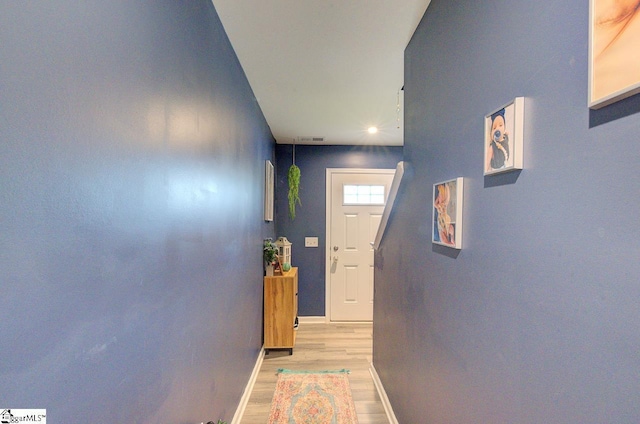 doorway with baseboards, recessed lighting, light wood-style flooring, and visible vents