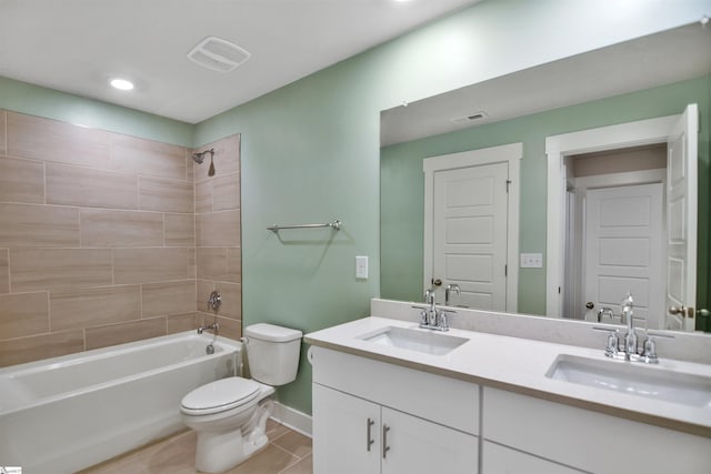 bathroom with toilet, baseboards,  shower combination, and a sink
