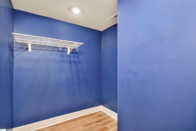 spacious closet with wood finished floors