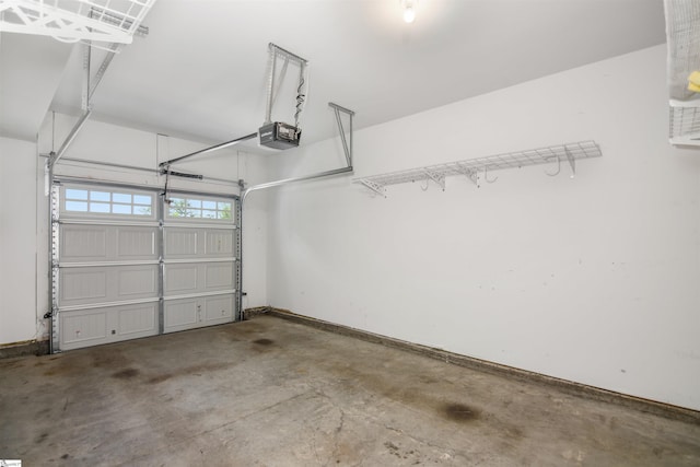garage with baseboards and a garage door opener