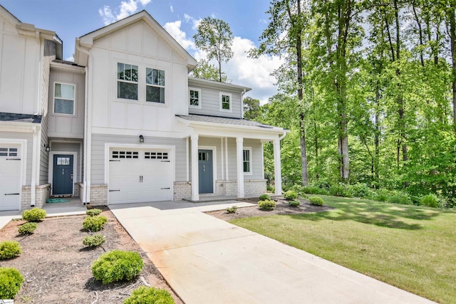 view of front of house featuring a garage, a front lawn, covered porch, board and batten siding, and concrete driveway
