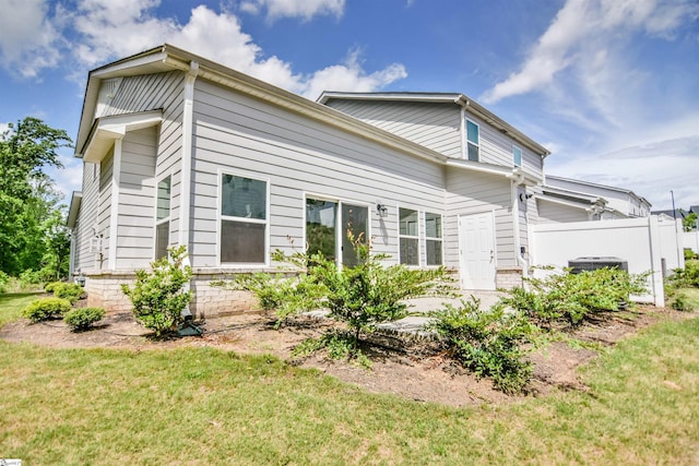 view of property exterior featuring fence, a yard, and cooling unit