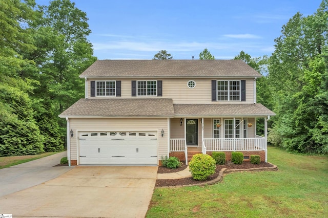 traditional home featuring roof with shingles, an attached garage, a porch, a front yard, and concrete driveway
