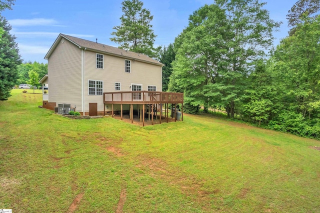 rear view of house featuring a yard, a deck, and cooling unit