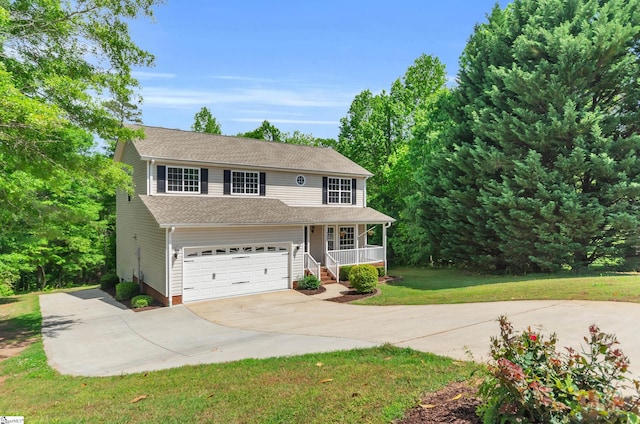 traditional-style house with a porch, an attached garage, driveway, and a front yard