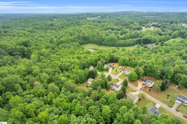 drone / aerial view featuring a wooded view