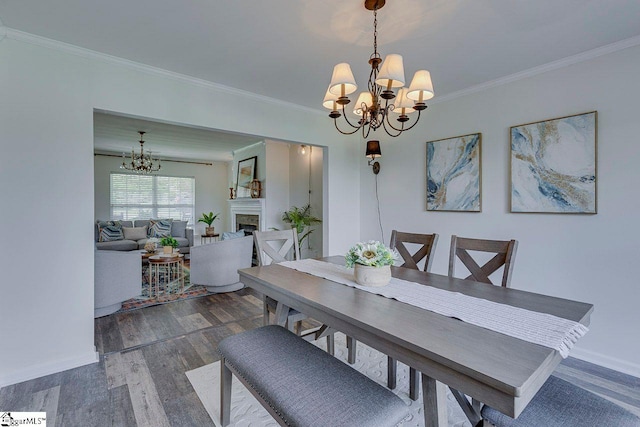 106 Hickory Valley Way, Taylors, SC 29687 - dining area with crown molding, a fireplace, a chandelier, baseboards, and dark wood-style floors