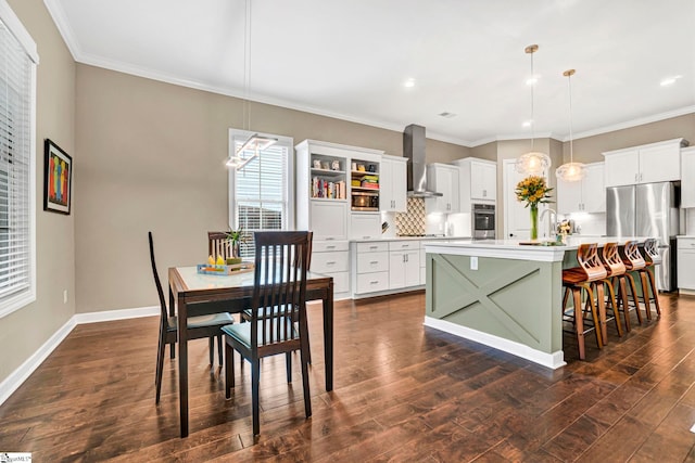 kitchen with backsplash, appliances with stainless steel finishes, a center island with sink, light countertops, and wall chimney exhaust hood
