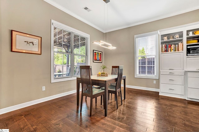 dining area featuring baseboards, ornamental molding, a wealth of natural light, and visible vents