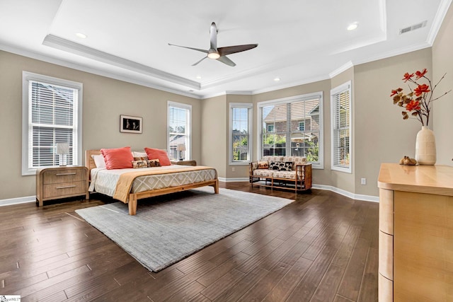 bedroom with baseboards, visible vents, dark wood-style floors, and a raised ceiling
