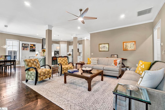 living room with a ceiling fan, visible vents, ornamental molding, and hardwood / wood-style flooring