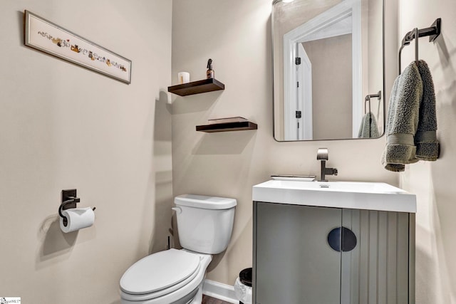 bathroom featuring toilet and vanity