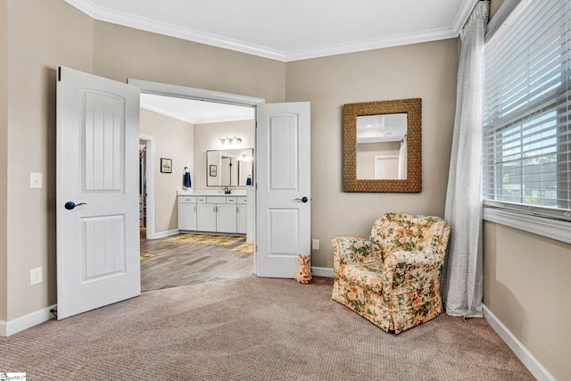 living area featuring baseboards, carpet flooring, and crown molding