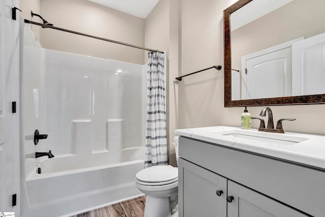 bathroom featuring vanity, toilet, wood finished floors, and shower / bath combination with curtain